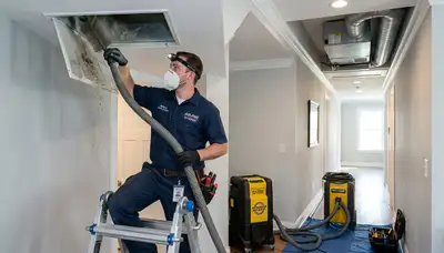 Technician cleaning air ducts for HVAC system in Boston MA home by Five Star Cooling